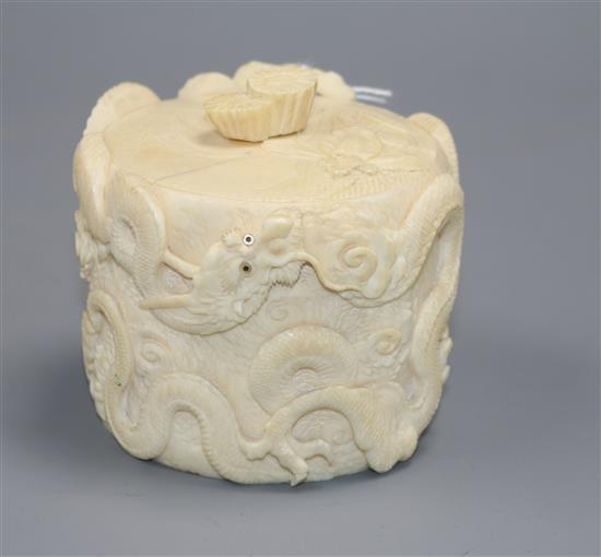 A Japanese Meiji period tusk box and cover carved with dragons with mother of pearl eyes, H 8cm